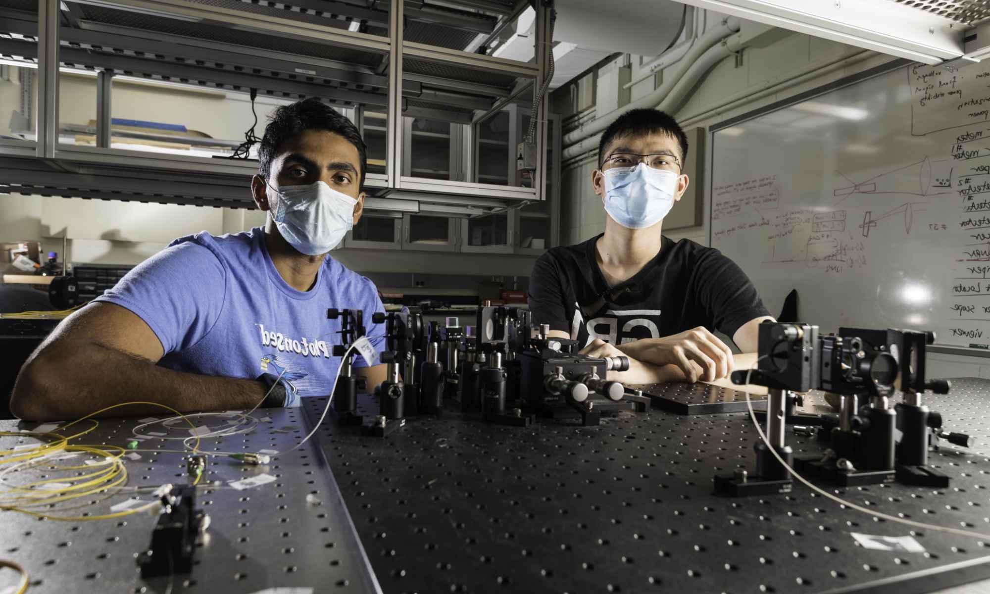 Optics students wearing masks in a lab.